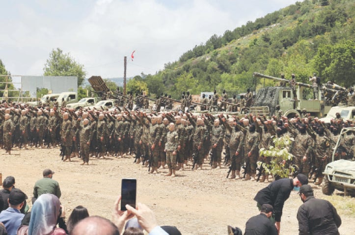 AARAMTA (Lebanon): Hezbollah fighters parade during an exercise in the southern Lebanese village near the Israeli border, on Sunday. During the large-scale drill, they simulated cross-border raids, using live ammunition and an attack drone.—AFP