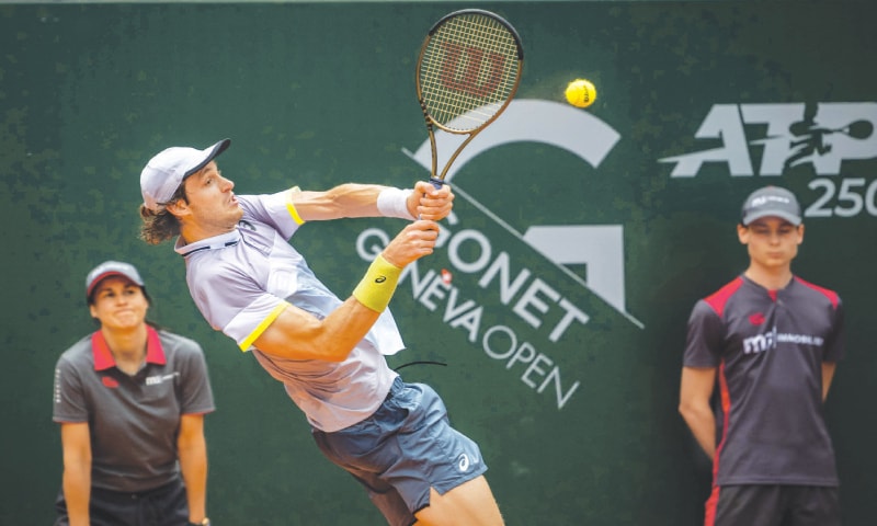 GENEVA: Chile&rsquo;s Nicolas Jarry hits a return to Grigor Dimitrov of Bulgaria during the final of the Geneva Open on Saturday.&mdash;AFP