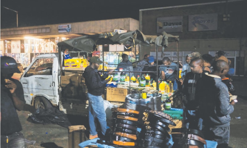 A small two-tonne truck is converted into an informal mobile pop-up shop selling basic groceries along Robert Mugabe Road in central Harare. Zimbabwe&rsquo;s rate of inflation has shot through the roof in recent weeks. Inflation hit and cash-crunched Zimbabweans are turning to the informal sector where vendors &mdash; with little or no overheads &mdash; can afford to undercut big supermarkets hawking goods on the streets.&mdash;AFP