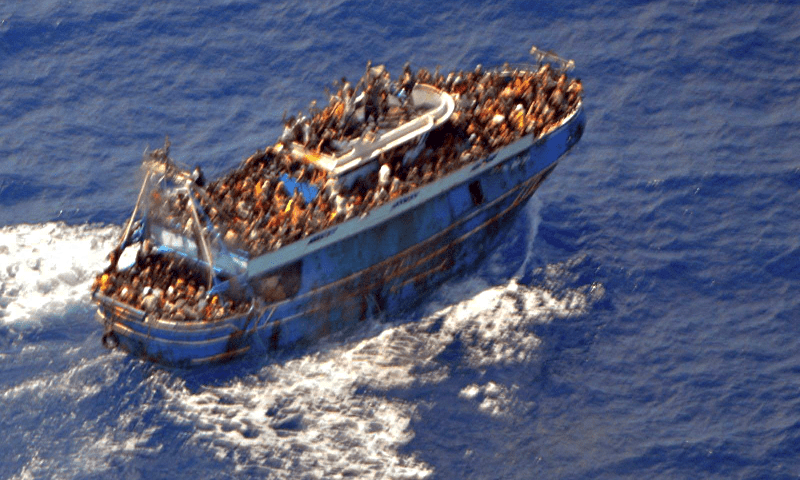 An undated handout photo provided by the Hellenic Coast Guard shows migrants onboard a boat during a rescue operation, before their boat capsized on the open sea, off Greece on June 14. — Reuters