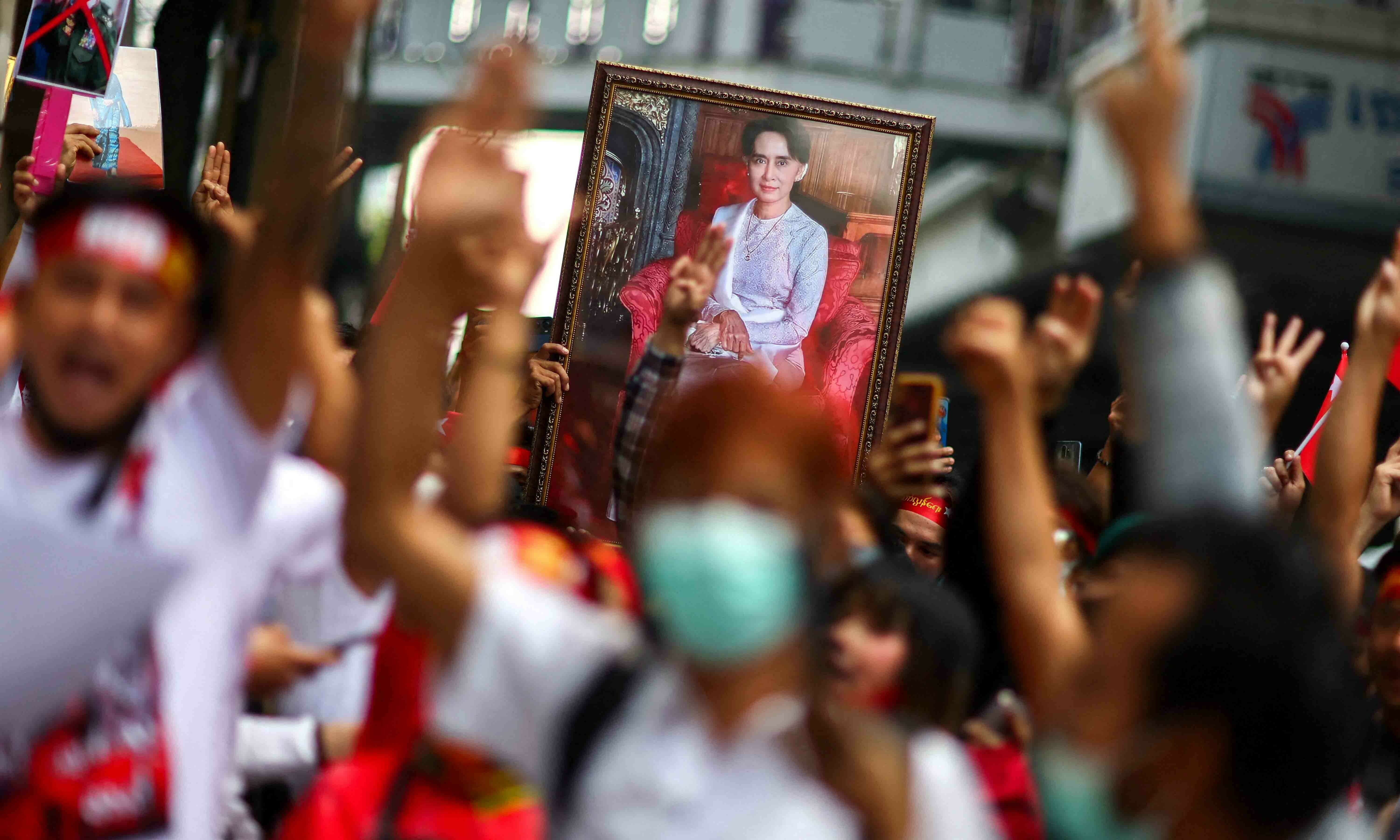 Protesters hold up a portrait of Aung San Suu Kyi and raise three-finger salutes, during a demonstration to mark the second anniversary of Myanmar’s 2021 military coup, outside the Embassy of Myanmar in Bangkok, Thailand, February 1. — Reuters Protesters hold up a portrait of Aung San Suu Kyi and raise three-finger salutes, during a demonstration to mark the second anniversary of Myanmar’s 2021 military coup, outside the Embassy of Myanmar in Bangkok, Thailand, February 1. — Reuters