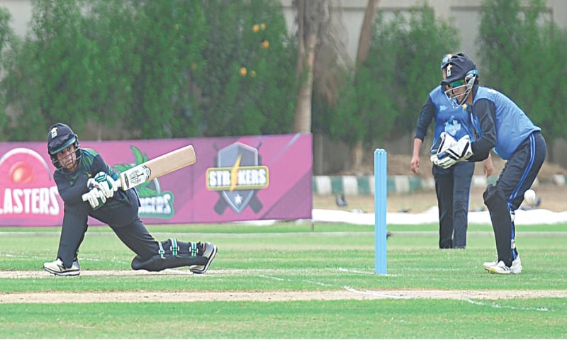 KARACHI: Challengers’ opener Javeria Khan plays a sweep shot as Dynamites wicket-keeper Sidra Nawaz looks on during their match of the women’s Pakistan Cup at the State Bank Stadium on Friday.—Tahir Jamal/White Star