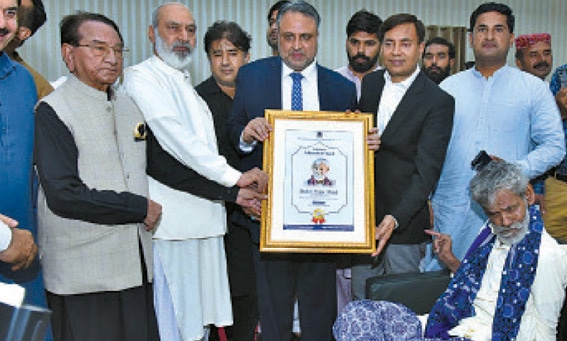 Shakir Shujaabadi, seated extreme right, gets award. &mdash;  Courtesy IUB