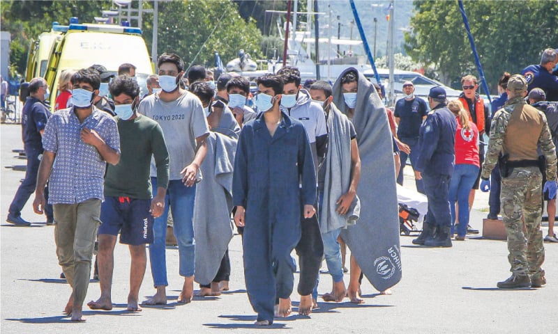 Survivors arrive at the Kalamata port, after around 100 people were rescued following the sinking of a migrant fishing boat in the Ionian Sea on Wednesday.—AFP