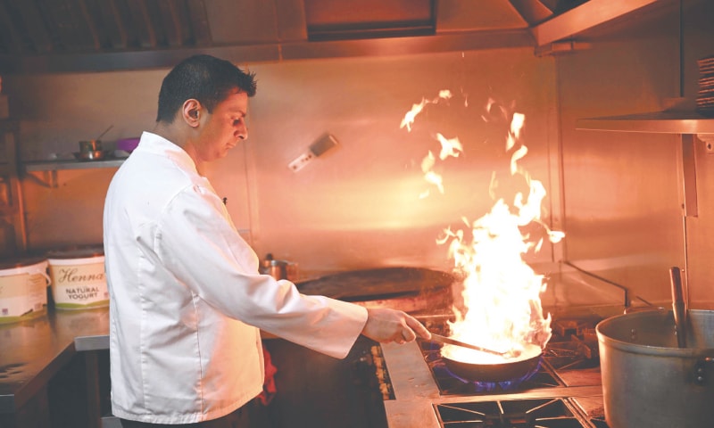 ZAF Hussain, the head chef at &lsquo;Shababs&rsquo;, creates a balti dish in the kitchen of his restaurant in &lsquo;Balti Triangle&rsquo; area of Birmingham. The authentic balti dish is cooked using vegetable oil, not ghee, in a bowl made of pressed carbon steel.&mdash;AFP
