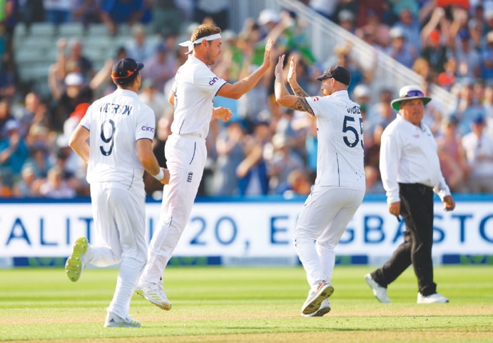 FAST bowler Stuart Broad (second L) celebrates with captain Ben Stokes after taking the wicket of Steve Smith.—Reuters