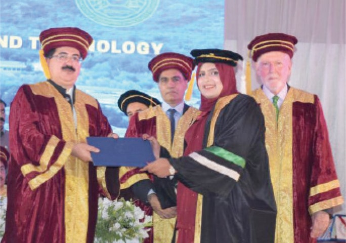 A student receives her degree from Senate Chairman Sadiq Sanjrani during the convocation. &mdash; Dawn