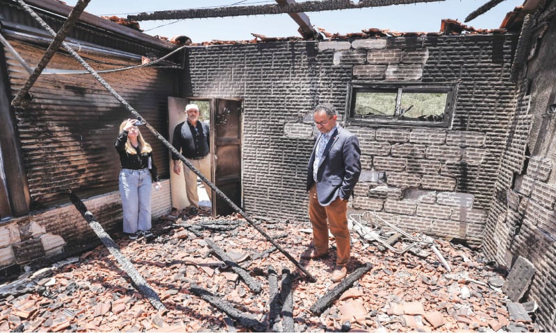 PEOPLE stand inside a destroyed building during a visit by a delegation to the village of Turmus Ayya, near the occupied West Bank city of Ramallah, in the aftermath of an attack there by Israeli settlers.&mdash;AFP