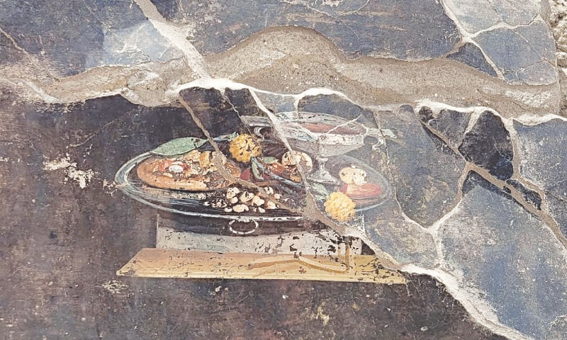 A 2,000-year-old Pompeian painting, a still life depicted on the wall of an ancient house that could be a distant ancestor of modern pizza.—AFP A 2,000-year-old Pompeian painting, a still life depicted on the wall of an ancient house that could be a distant ancestor of modern pizza.—AFP