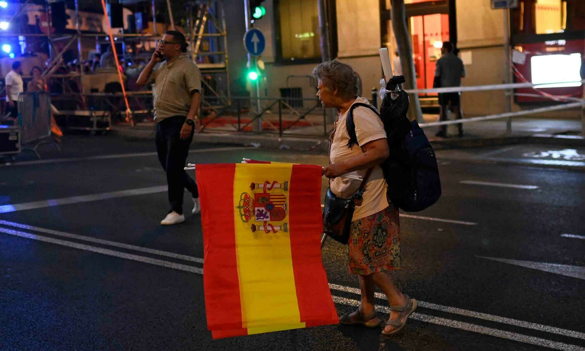 A woman sells Spain&rsquo;s national flags in front of the headquarters of the leader and candidate of conservative Partido Popular (People&rsquo;s Party) Alberto Nunez Feijoo in Madrid on July 23. &mdash; AFP