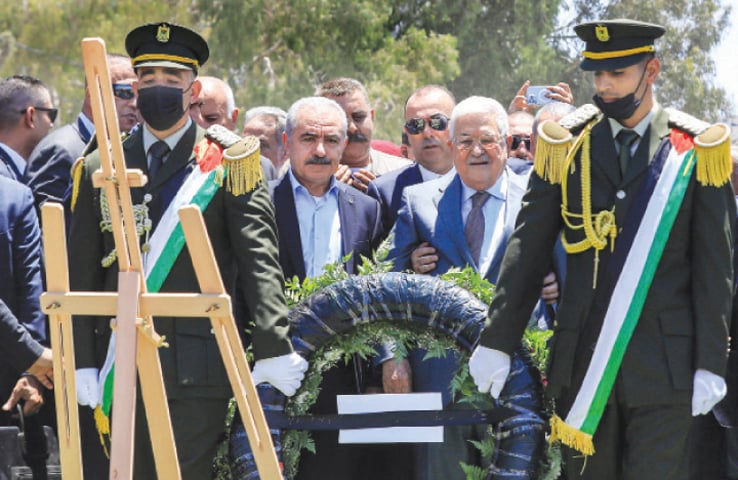  Occupied West Bank: Palestinian President Mahmud Abbas and Prime Minister Mohammad Shtayyeh (centre left) arrive to lay a wreath of flowers by the graves of those killed in recent Israeli military raids on the Jenin camp for refugees, on Wednesday.&mdash;AFP 