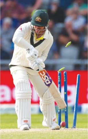 AUSTRALIAN opener David Warner is cleaned up by England pacer Chris Woakes.—Reuters