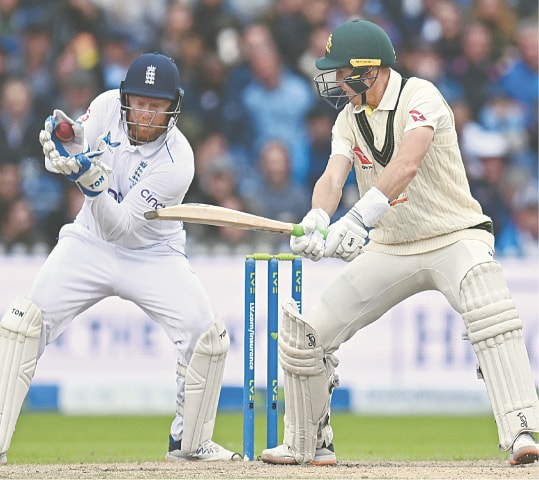ENGLAND wicket-keeper Jonny Bairstow takes a catch to dismiss Australian batter Marnus Labuschagne off the bowling of Joe Root during the fourth Ashes Test at Old Trafford on Saturday.&mdash;AFP
