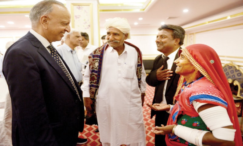One-Man Commission for Minorities Chairman Dr Sohaib Suddle shares a light moment with Oogo Bheel and his wife Lachhmi Bheel during the HRCP consultation on Tuesday. &mdash; Photo by Tanveer Shahzad