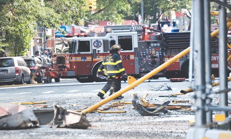 DEBRIS from the crane collapse clogs the road as police, firefighters and emergency personnel gather at the scene in Manhattan.&mdash;AFP
