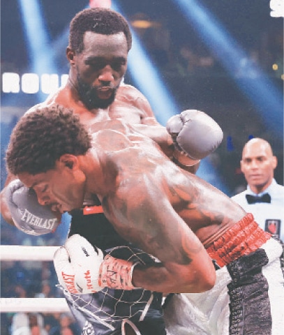 Terrence Crawford lands an upper cut on Errol Spence Jr. during their World Welterweight Championship bout at T-Mobile Arena.&mdash;AFP