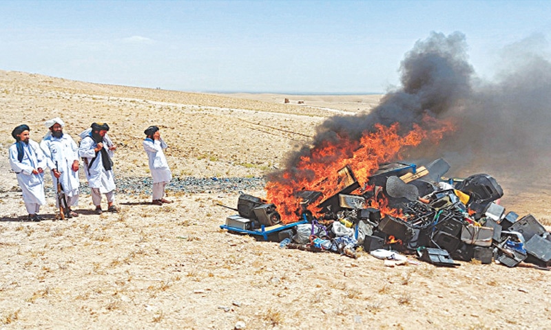 THIS photograph released by the Afghan government shows Taliban setting fire to musical instruments and
equipment on the outskirts of Herat.—AFP THIS photograph released by the Afghan government shows Taliban setting fire to musical instruments and
equipment on the outskirts of Herat.—AFP