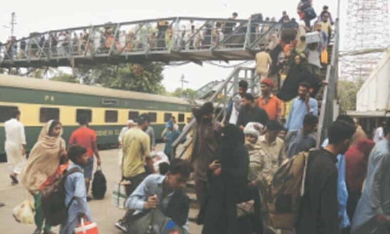 Train passengers at the Karachi Cantonment Station walk downstairs on a pedestrian bridge to go back to their homes as railway operations come to a halt after the derailment incident near Nawabshah on Sunday. — Shakil Adil Train passengers at the Karachi Cantonment Station walk downstairs on a pedestrian bridge to go back to their homes as railway operations come to a halt after the derailment incident near Nawabshah on Sunday. — Shakil Adil