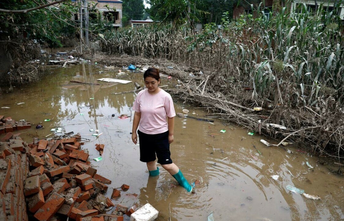 Wang Dan, 30, stands in floodwaters near a damaged corn farm, after rain and floods brought by remnants of Typhoon Doksuri, at a village in Zhuozhou, Hebei province, China August 7, 2023. — Reuters Wang Dan, 30, stands in floodwaters near a damaged corn farm, after rain and floods brought by remnants of Typhoon Doksuri, at a village in Zhuozhou, Hebei province, China August 7, 2023. — Reuters