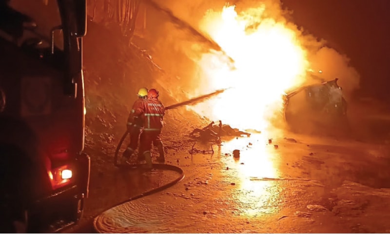 Rescue 1122 firemen try to put out the flames engulfing the oil tanker in Talash, Lower Dir, on Saturday night. — Dawn Rescue 1122 firemen try to put out the flames engulfing the oil tanker in Talash, Lower Dir, on Saturday night. — Dawn
