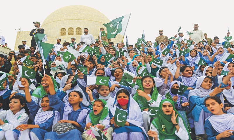 Students wave national flags at the mausoleum of Quaid-i-Azam Mohammad Ali Jinnah during Independence Day celebrations on Monday.—AFP Students wave national flags at the mausoleum of Quaid-i-Azam Mohammad Ali Jinnah during Independence Day celebrations on Monday.—AFP