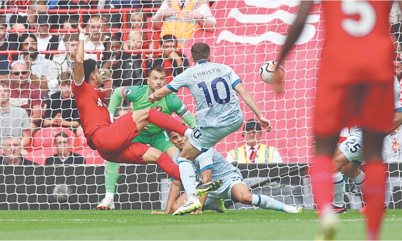 LIVERPOOL: Luis Diaz (L) of Liverpool scores acrobatically past Bournemouth goalkeeper Neto during their Premier League match at Anfield on Saturday.&mdash;Reuters