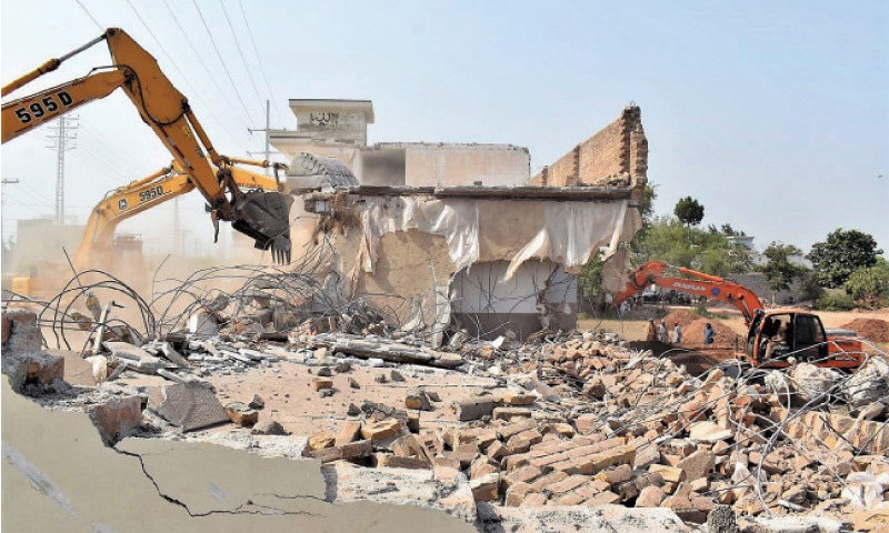 Heavy machinery being used to demolish illegal structures on Northern Bypass, Peshawar, on Wednesday. &mdash; White Star