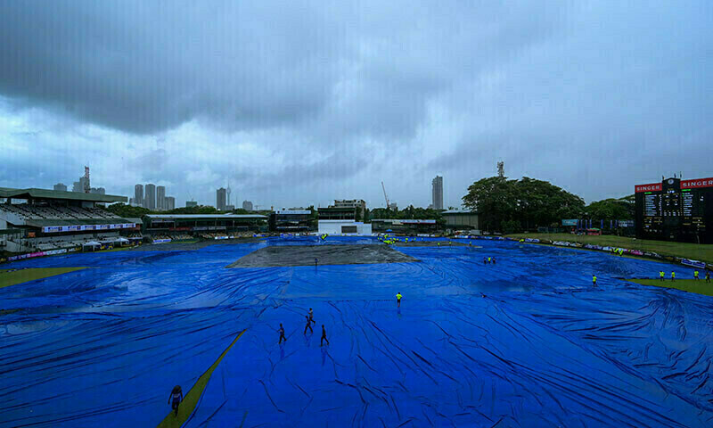 Members of ground staff cover the pitch as rain stops the second day play of the second and final cricket Test match between Pakistan and Sri Lanka at the Sinhalese Sports Club (SSC) Ground in Colombo on July 25, 2023. &mdash; AFP