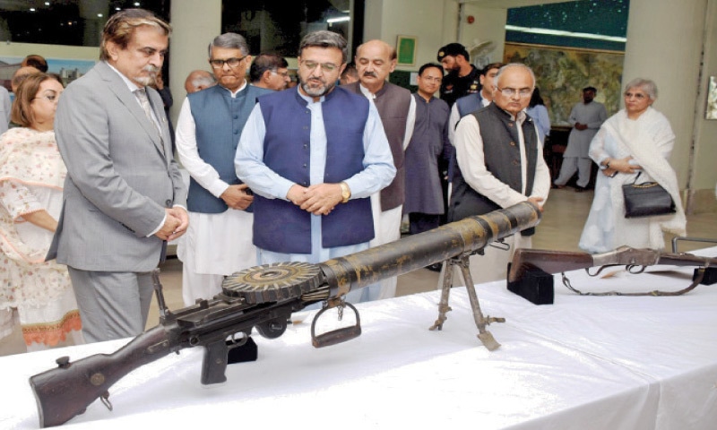Caretaker Minister of Cultural Heritage Jamal Shah looks at antique weapons on display in Islamabad on Friday. &mdash; White Star