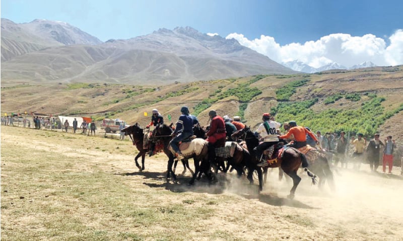 A match of buzkashi under way between village teams on the final day of Broghil festival in Upper Chitral. Buzkashi is a traditional sport in which horse-mounted players attempt to place a goat carcass in a goal. &mdash; Dawn