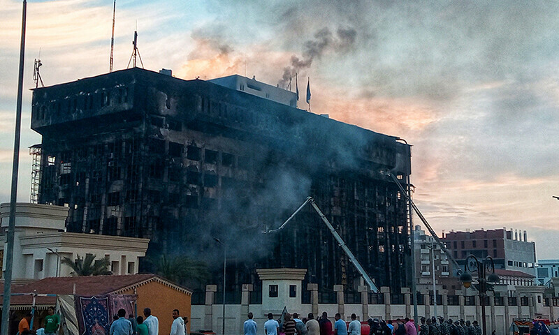 Firefighters try to extinguish a fire at a police headquarters in Ismailia on October 2, 2023. A huge fire broke out at the police headquarters in the Egyptian city of Ismailia on October 2, injuring at least 25 people, according to security sources.—AFP