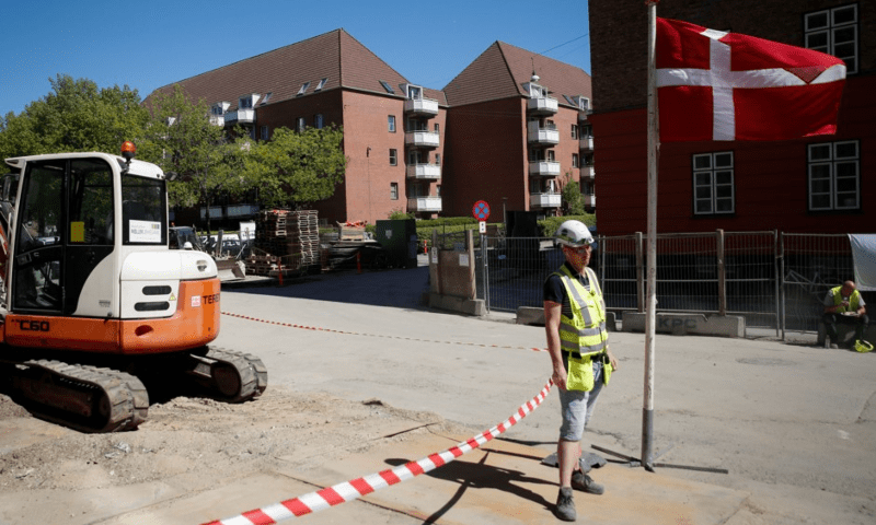 A worker stands beside a Danish flag on a construction site of a new housing being built next to Mjølnerparken, a Copenhagen housing project on the Danish government’s “Ghetto List” on May 8, 2018. — Reuterss/File A worker stands beside a Danish flag on a construction site of a new housing being built next to Mjølnerparken, a Copenhagen housing project on the Danish government’s “Ghetto List” on May 8, 2018. — Reuterss/File