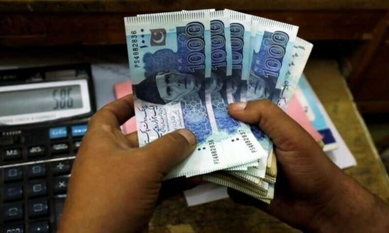 A trader counts Pakistani rupee notes at a currency exchange booth in Peshawar, December 3, 2018. — Reuters/File