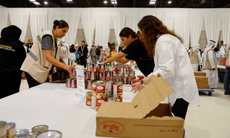  Members of the Emirati Red Crescent and volunteers prepare humanitarian aid and food supplies for Palestinians during a donation campaign in Dubai, United Arab Emirates on October 21. &mdash; Reuters 