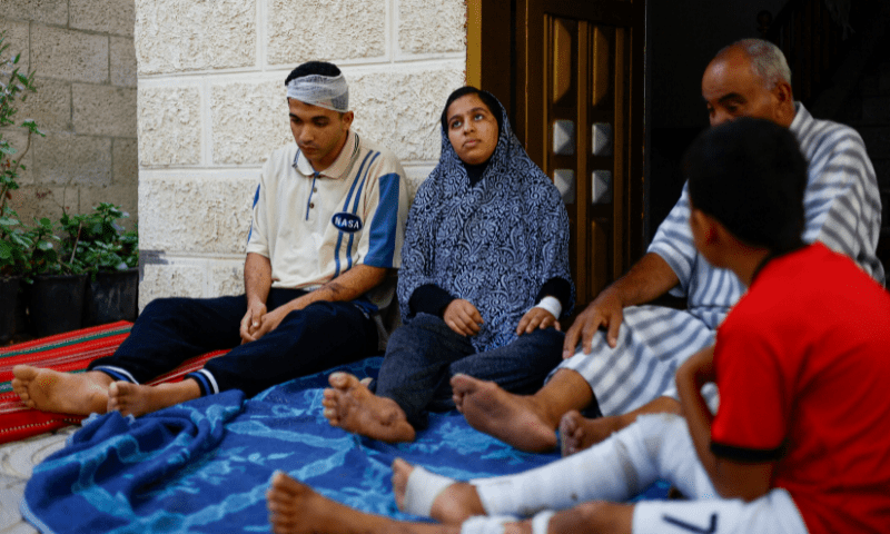 Dima Allamdani and her brother Hamza sit among others, in Khan Younis in the southern Gaza Strip. &mdash; Reuters/Mohammed Salem