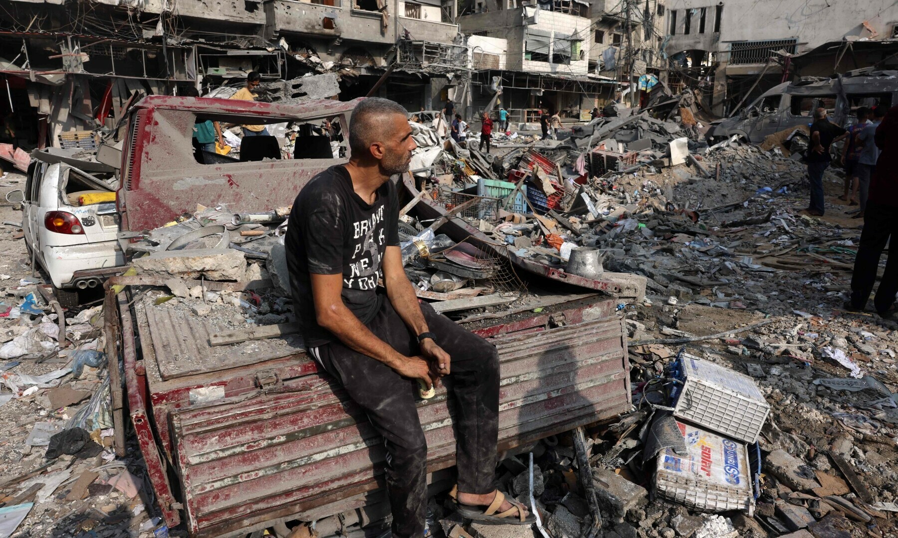  A man sits amid the destruction following Israeli strikes on Al-Shatee camp in Gaza City on October 28. &mdash; AFP 