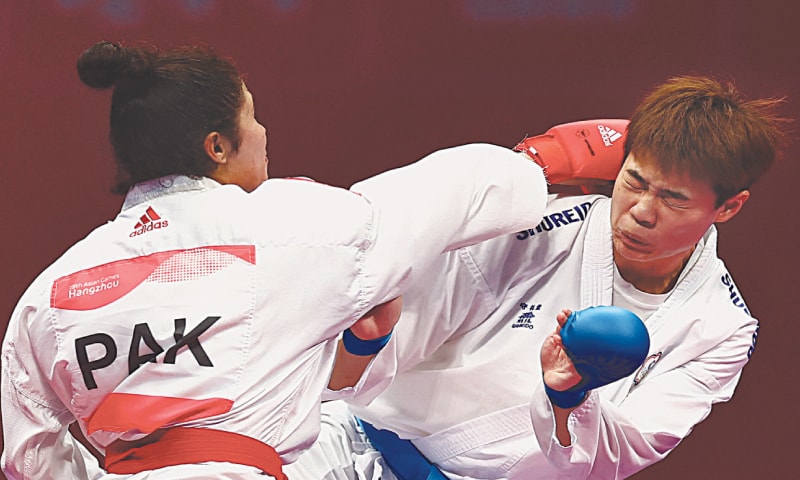 PAKISTAN’S Fakhar-Un-Nisa in action against Chao Jou of Chinese Taipei during their Kumite -68kg Repechage first-round bout at the Linping Sports Centre on Thursday.—Reuters PAKISTAN’S Fakhar-Un-Nisa in action against Chao Jou of Chinese Taipei during their Kumite -68kg Repechage first-round bout at the Linping Sports Centre on Thursday.—Reuters