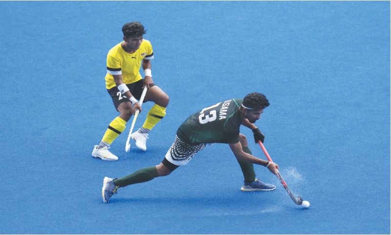 PAKISTAN’S Usama Bashir in action during the fifth-place hockey match against Malaysia in the
Asian Games at the Gongshu Canal Sports Park Stadium on Friday.—Reuters PAKISTAN’S Usama Bashir in action during the fifth-place hockey match against Malaysia in the
Asian Games at the Gongshu Canal Sports Park Stadium on Friday.—Reuters