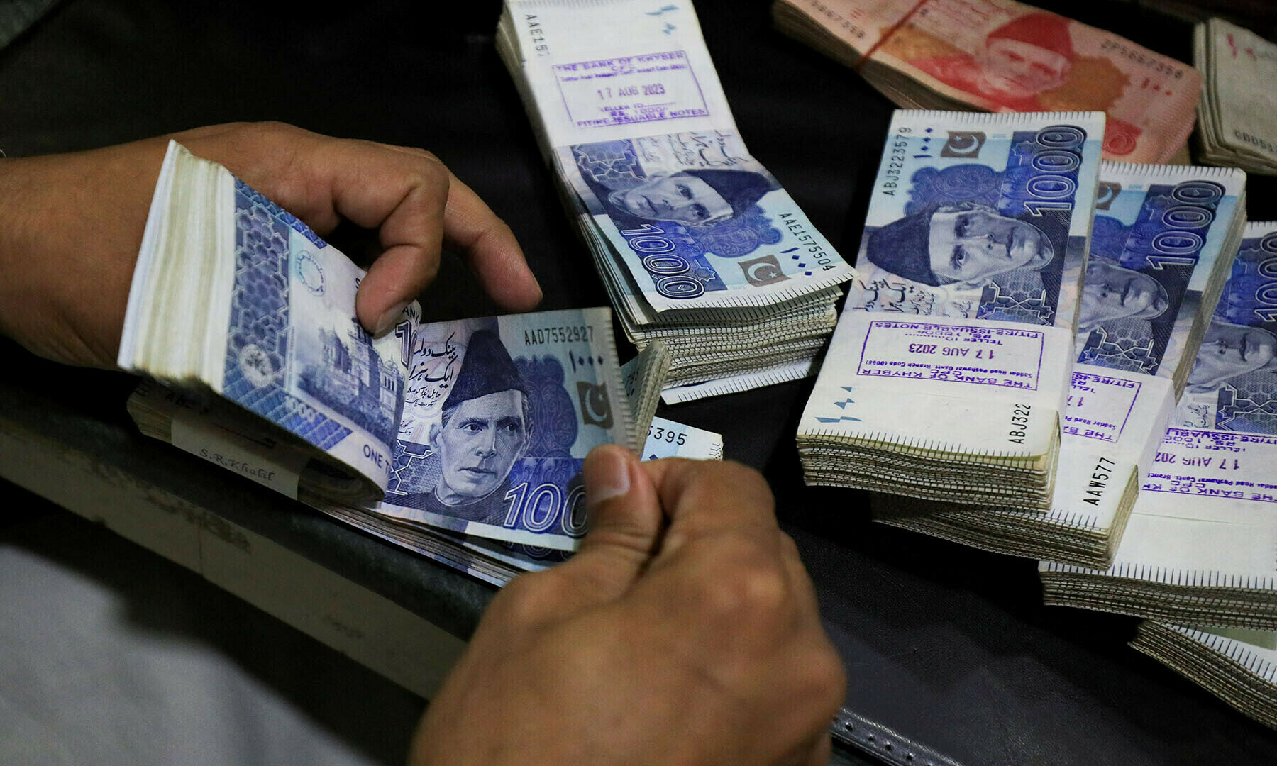 An employee counts Pakistani rupee notes at a bank in Peshawar, Pakistan August 22, 2023. —Reuters/File An employee counts Pakistani rupee notes at a bank in Peshawar, Pakistan August 22, 2023. —Reuters/File