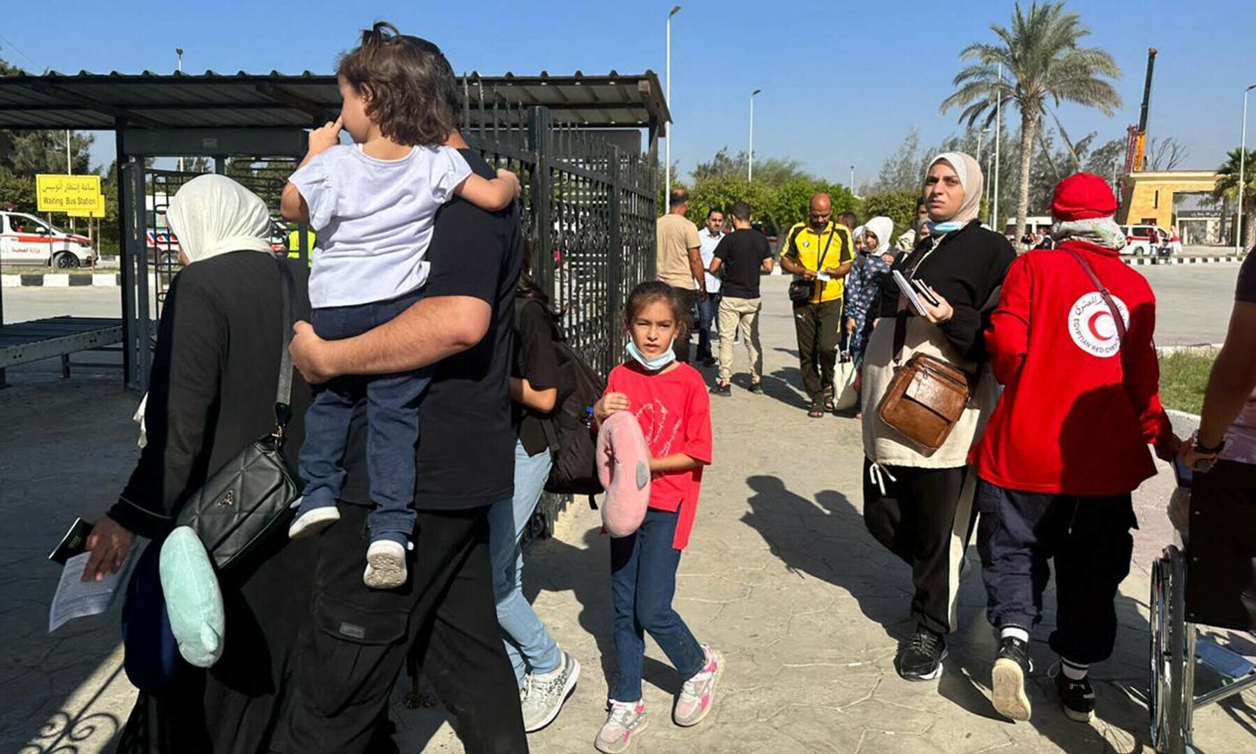 People cross into Egypt&rsquo;s Rafah border crossing with the Gaza Strip, on November 9, 2023, amid the ongoing battles between Israel and the Palestinian group Hamas. (Photo by AFP)