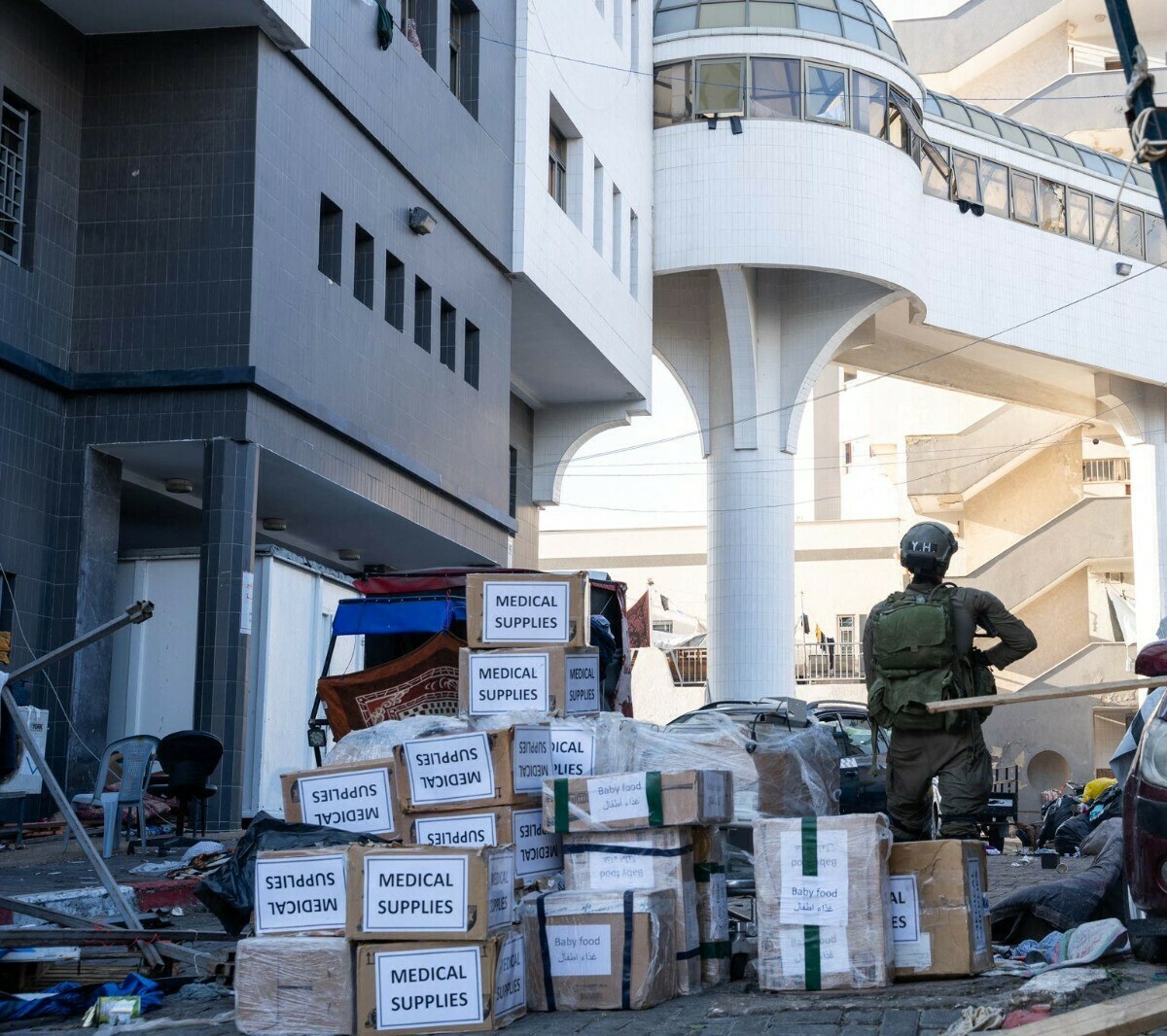 This handout picture released by the Israeli army on November 15 shows a soldier standing outside Al-Shifa hospital next to boxes of medical supplies the army said it had delivered to the health centre during their operation at Al-Shifa in Gaza City. &mdash; AFP