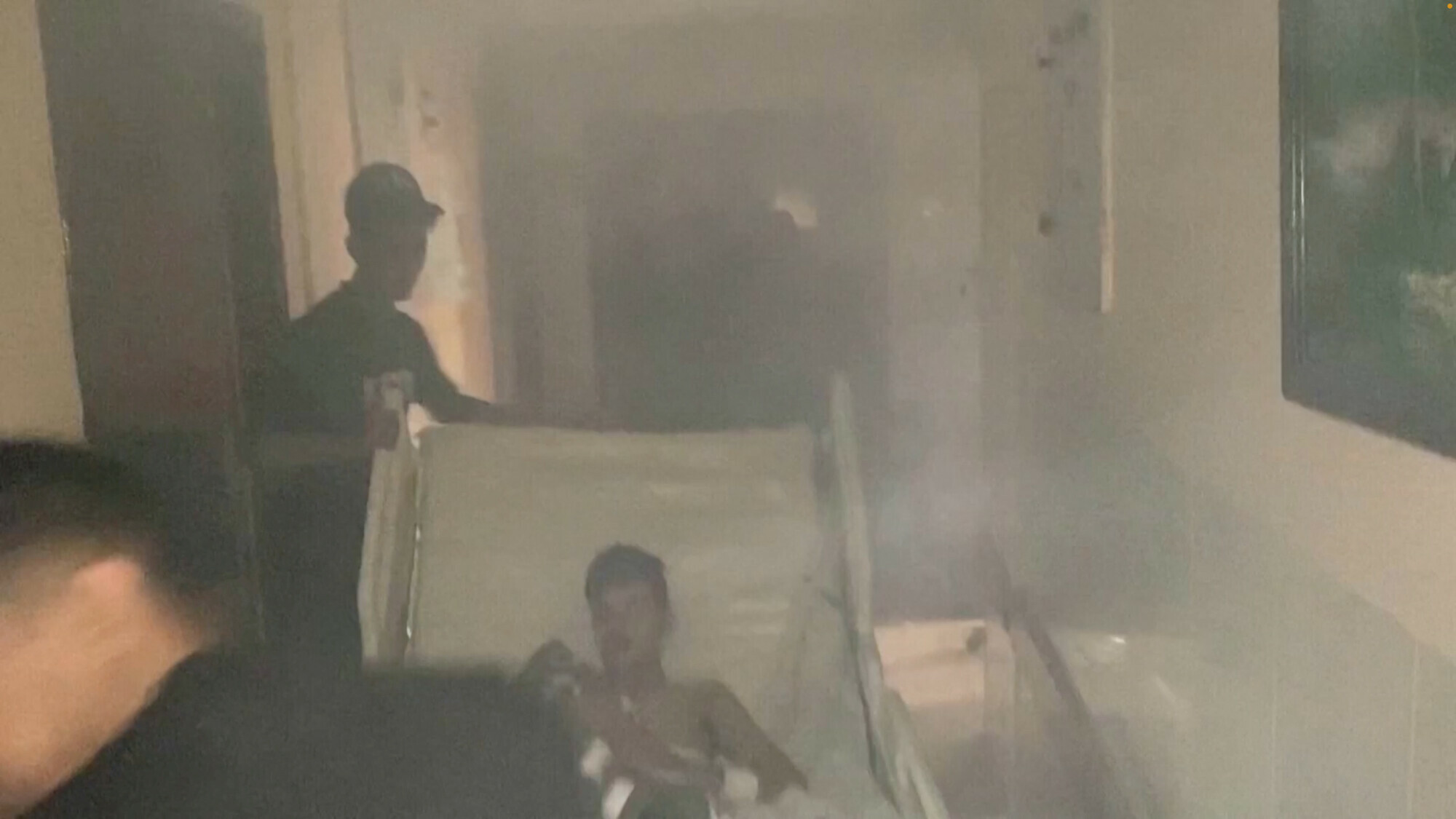 Medics move a patient through the smoke-filled corridors inside Al-Shifa hospital following an Israeli raid in Gaza City, Gaza, November 15. &mdash; Reuters 