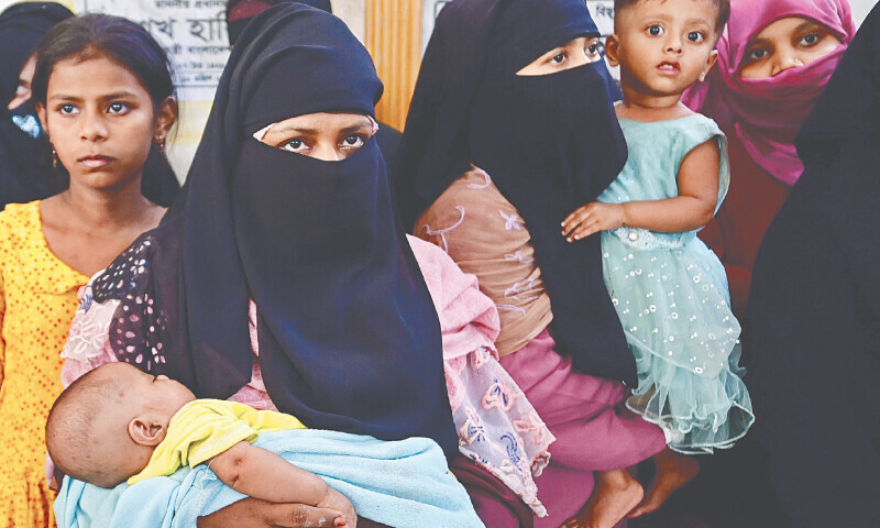 ROHINGYA refugees at a police station in Teknaf, Bangladesh, on Saturday.&mdash;AFP