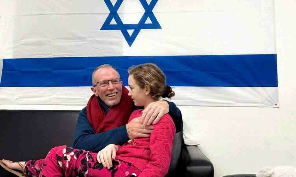 Irish-Israeli girl Emily Hand, who was abducted by Hamas fighters during the October 7 attack on Israel, meets her father Thomas Hand after being released as part of a deal between Hamas and Israel amid a temporary truce, at an unknown location in Israel, in this handout image released November 26. — Reuters