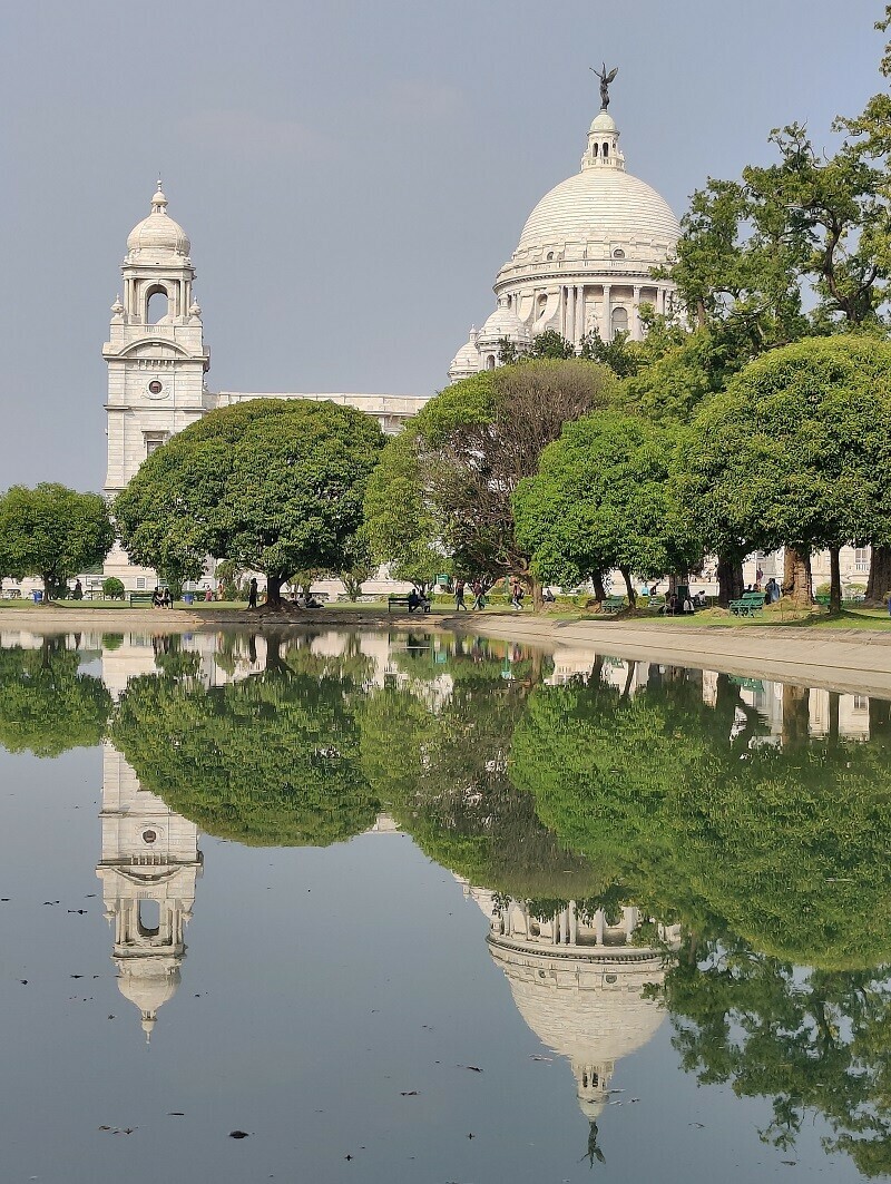 The legislative building is surrounded by greenery.