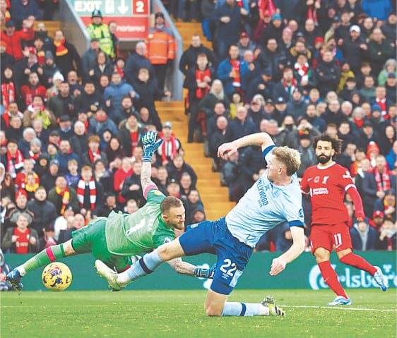 LIVERPOOL: Mohamed Salah (R) of Liverpool scores against Brentford during their Premier League match at Anfield on Sunday.&mdash;Reuters