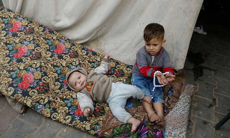 Palestinian infant Yazan Rehan lies on a mattress at a school sheltering people who fled their houses due to Israeli strikes, in Rafah in the southern Gaza Strip, December 7, 2023. &mdash; Reuters