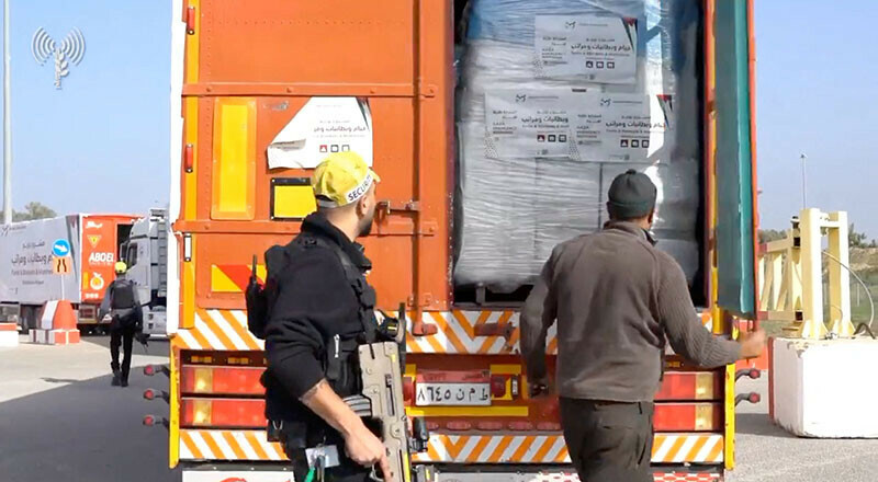 A humanitarian aid truck is inspected at the Kerem Shalom crossing on the border between Israel, Gaza and Egypt on December 12, 2023. &mdash; Reuters via COGAT