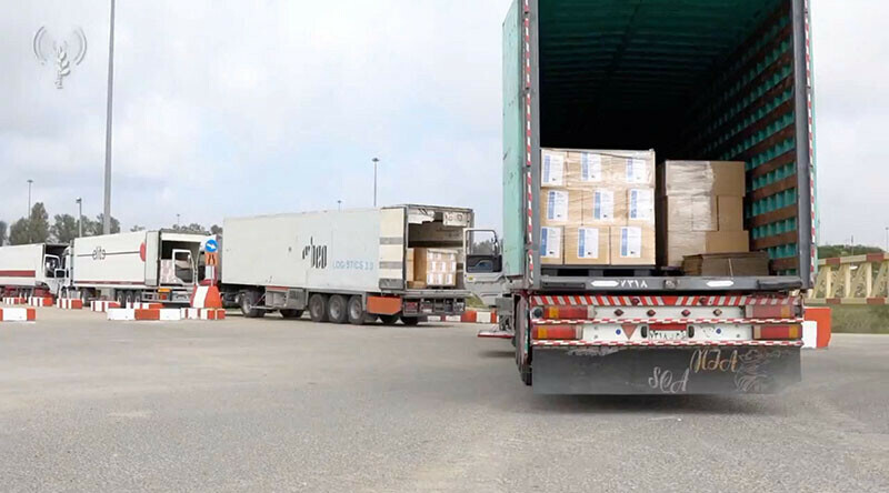 Humanitarian aid trucks wait in line to be inspected at the Kerem Shalom crossing on the border between Israel, Gaza and Egypt on December 12, 2023. &mdash; Reuters via COGAT