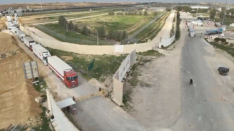 Humanitarian aid trucks wait in line to be inspected at the Kerem Shalom crossing on the border between Israel, Gaza and Egypt on December 12, 2023. &mdash; Reuters via COGAT